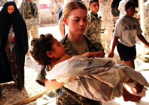 Soldier with wounded Iraqi child (PDI)
