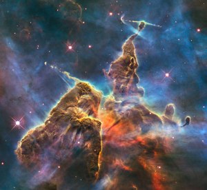 Mystic Mountain, in the constellation Carina. The formation is three light years tall, full of baby stars letting off jets of gas.  "Hubble’s Wide Field Camera 3 observed the pillar on 1-2 February 2010. The colours in this composite image correspond to the glow of oxygen (blue), hydrogen and nitrogen (green), and sulphur (red)." --ESA/Hubble Credit: NASA, ESA, M. Livio and the Hubble 20th Anniversary Team (STScI) 