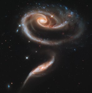 Arp 273, two interacting galaxies in the constellation of Andromeda, about 300 million light years from Earth. The smaller one is actively forming new stars and is thought to have passed through the larger, reshaping it into a form that resembles a stemmed rose.  Credit: NASA, ESA and the Hubble Heritage Team (STScI/AURA)